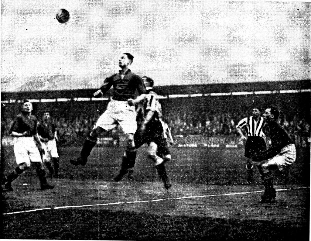 Gilchrist, the visitors right back, heading away from a centre from Carter while Swift, the former Southport Goalkeeper, looks on.