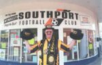Programme Editor Derek Hitchcock outside the club shop on Lord Street